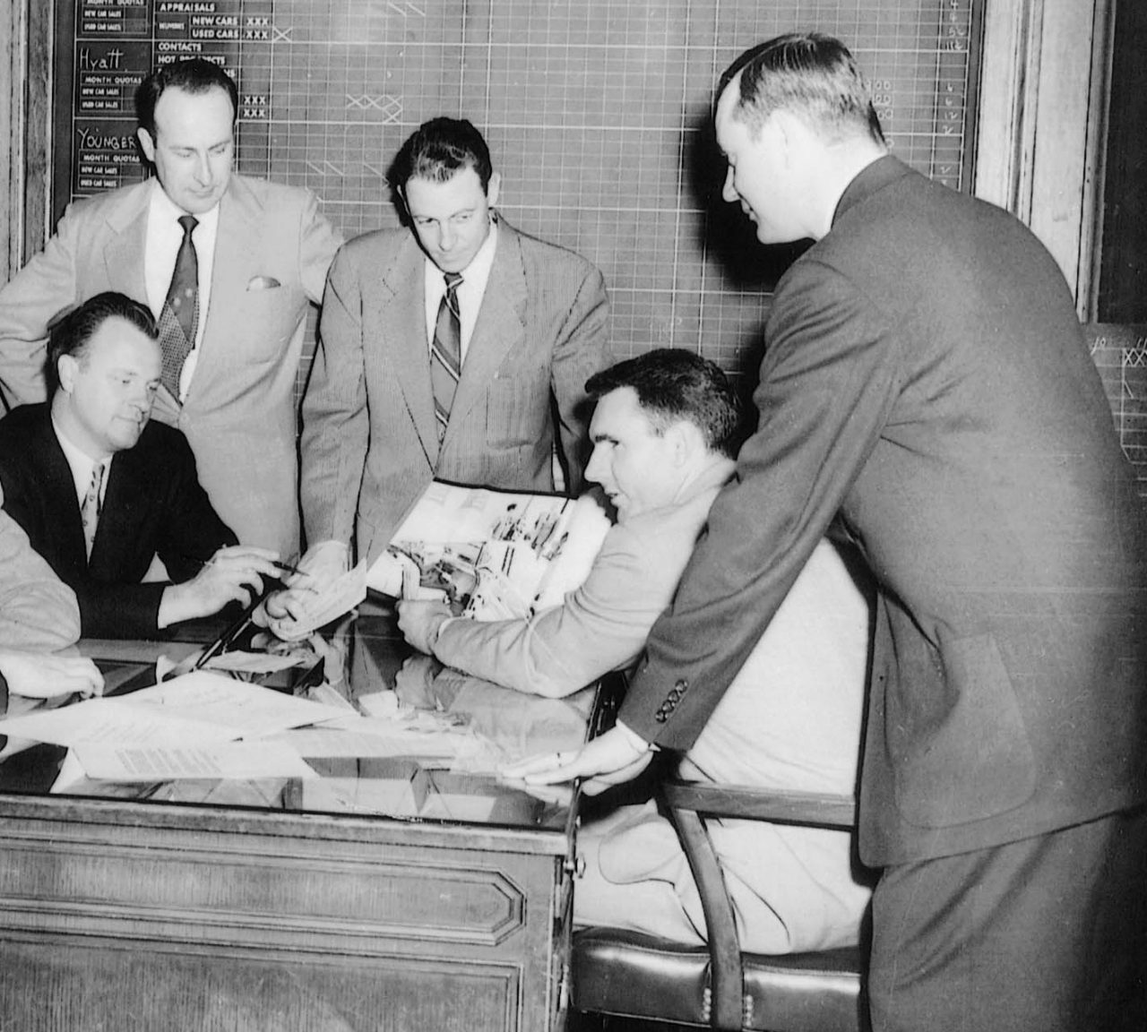Founder Jack Taylor leads a meeting with a group in 1957