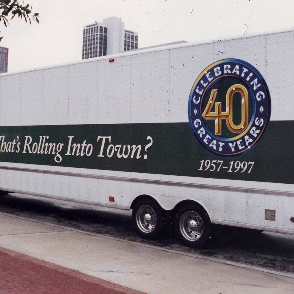 Enterprise 40-year anniversary signage on a long bus