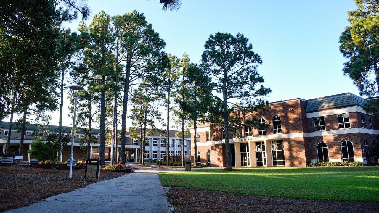 Trees, grass and buildings on a sunny day at Sandhills Community College campus.